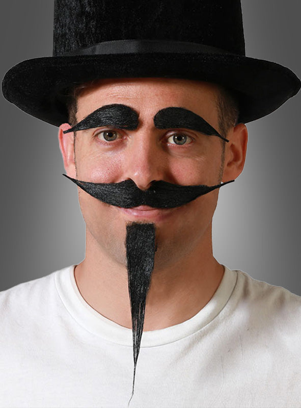 Ein Mann mit schwarzem Zylinder und weißem Hemd präsentiert auf humorvolle Weise das „Bart-und-Augenbrauen-Set schwarz“ auf seinem Gesicht – ideal für jede Kostümparty.