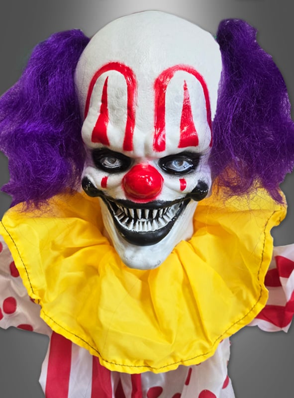 Entdecken Sie den „Clown Deko Akrobaten 180 cm, animiert mit Bewegungsmelder“ – eine gruselige Figur mit lila Haaren, einer roten Nase, auffälligem rotem Make-up, scharfen Zähnen, einem gelben Rüschenkragen und einem farbenfrohen Kostüm mit Polka-Punkten. Ihre lebensechte Erscheinung und der Bewegungssensor machen sie zu einem unvergesslichen Stück für Ihre gruselige Sammlung oder zu einem auffälligen Highlight in Ihrer Clown-Halloween-Dekoration.