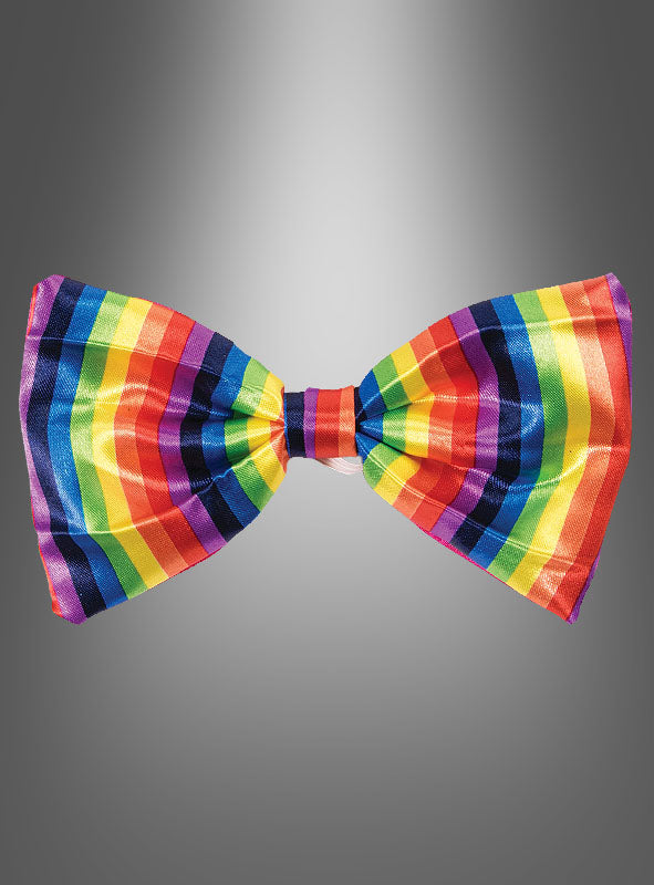 Eine bunte Fliege für ein Clownkostüm mit Regenbogenstreifen vor einem grauen Farbverlaufshintergrund – ideal als fröhliches Karnevalsaccessoire oder um jedem Clownkostüm eine verspielte Note zu verleihen.