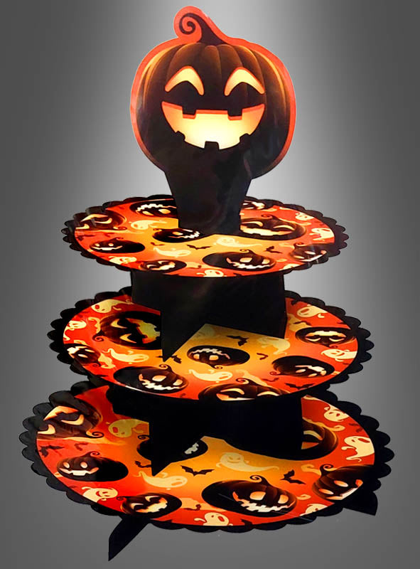 Die dreistöckige Halloween-Etagere „Kürbis“ besticht durch orangefarbene und schwarze Halloween-Motive, fröhlich lächelnde Kürbisse und Geister sowie einen großen Kürbis-Aufsatz – die perfekte Tischdekoration oder Süßigkeitenhalterung für Ihre gruseligen Halloween-Feiern.