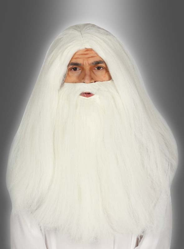 Eine Person mit langen weißen Haaren und einem vollen weißen Bart und Schnurrbart, die das „Merlin Perücke und Bart Set“ trägt und vor einem schlichten grauen Hintergrund mit Farbverlauf nach vorne blickt.