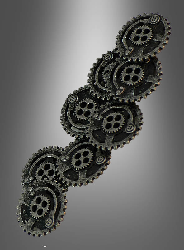 Eine Ansammlung sich überlappender schwarzer Metallzahnräder, inspiriert von den Steampunk-Zahnradknöpfen, ist diagonal vor einem grau verlaufenden Hintergrund angeordnet.