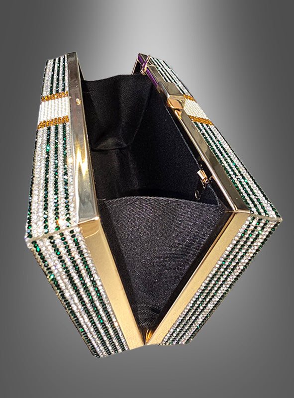 Dollar-Handtasche Deluxe mit Strass, eine Clutch mit goldfarbenem Rahmen und grünen sowie weißen Strassstreifen; geöffnet zeigt sie ein schwarzes Stofffutter vor einem sanften Farbverlauf im Hintergrund.