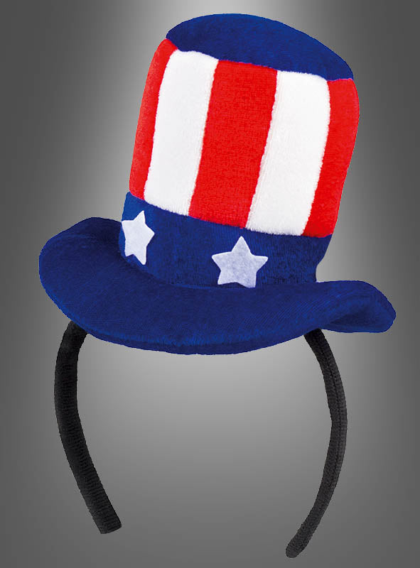 USA-Minizylinder mit Haarreif: Rot-weiß-blauer Plüsch-Uncle-Sam-Hut als Haarreif mit vertikalen Streifen und weißen Sternen auf einem blauen Band – ideal, um dein Uncle-Sam-Outfit zu vervollständigen oder deinem USA-Kostüm einen festlichen Touch zu verleihen, präsentiert vor grauem Hintergrund.