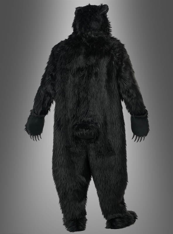 Eine Person, von hinten gesehen, die Arme leicht ausgestreckt, im „Schwarzbär-Kostüm Deluxe mit Ani-Motion-Maske“ vor einem grauen Hintergrund mit Farbverlauf.