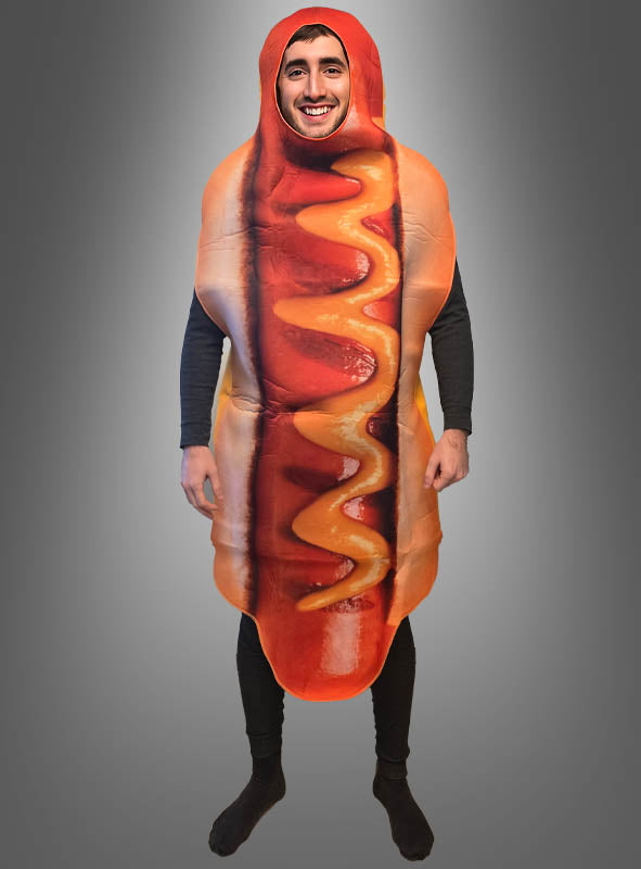 Eine Person trägt das Hot-Dog-Kostüm für Erwachsene mit einem lächelnden Gesichtsmotiv und steht vor einem einfarbigen grauen Hintergrund. Dieses Unisex-Spaßkostüm ist perfekt für alle, die jeder Veranstaltung eine Prise Spaß und Humor verleihen möchten.