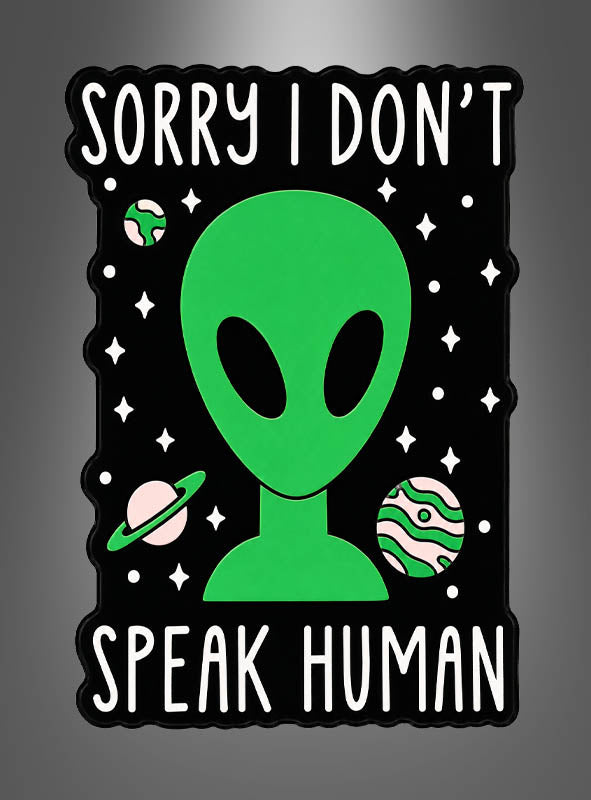 Eine Illustration eines grünen Außerirdischen mit Planeten und Sternen, auf der oberhalb und unterhalb des Außerirdischen auf schwarzem Hintergrund der Text „Sorry, ich spreche kein Menschisch“ zu lesen ist – perfekt für Fans von „Alien Pins Anstecker Weltall“ oder alle, die lustige Anstecker lieben.