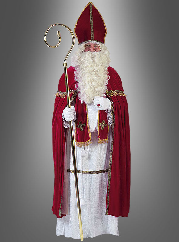 Gekleidet im Sankt-Nikolaus-Bischofskostüm – einer traditionellen Nikolaus-Tracht, bestehend aus einer rot-weißen Robe mit goldenen Verzierungen, einem hohen Hut, weißen Handschuhen und einem Stab – ist diese Figur perfekt für jede festliche Weihnachtsverkleidung gekleidet und hebt sich deutlich vom grauen Hintergrund ab.