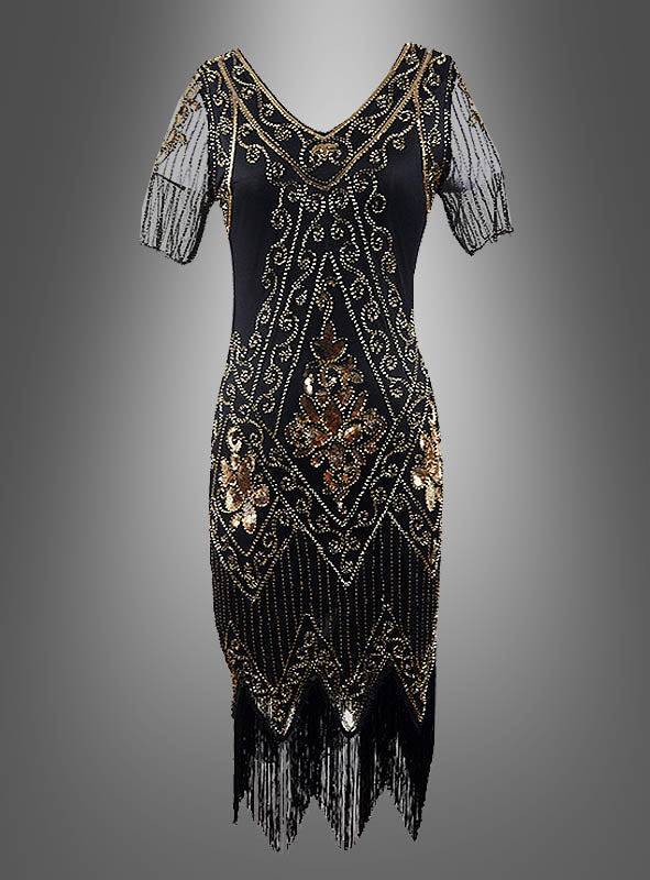 20er-Jahre-Paillettenkleid „Gitta“ in Schwarz mit transparenten Ärmeln, verziert mit goldenen und bronzefarbenen, perlenbesetzten geometrischen und floralen Mustern, transparenten Kurzarm-Ärmeln mit Perlendetails sowie einem Fransensaum – stilvoll präsentiert auf grauem Hintergrund und ideal als glamouröses 20er-Jahre-Kleid oder auffälliges Paillettenkleid für Damen für deine nächste 20er-Jahre-Party.