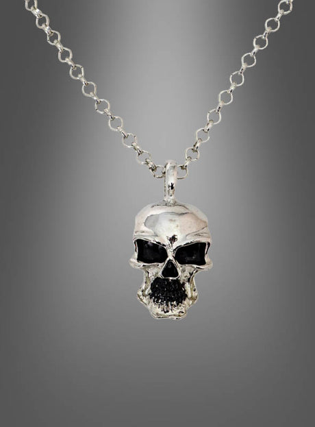 Die „Totenkopf Biker Pirat Kette silber aus Metall“ ist eine silberne Halskette mit einem metallischen Totenkopf-Anhänger, dessen Augen und Mund mit schwarzen Akzenten versehen sind, was sie zu einem idealen Halloween-Schmuckstück macht. Die elegante silberne Halskette wird vor einem grauen Hintergrund mit Farbverlauf präsentiert.