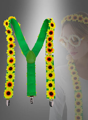 Die „Sonnenblumen-Hosenträger“ – grüne Hosenträger, verziert mit gelben Kunstsonnenblumen – werden zusammen mit einem passenden Stirnband und einer Brille geliefert, wie sie die Frau im Hintergrund trägt. Dieses Set ist das perfekte „Sonnenblumen-Kostüm“ oder ein farbenfrohes Hippie-Accessoire für Ihre nächste Mottoparty.