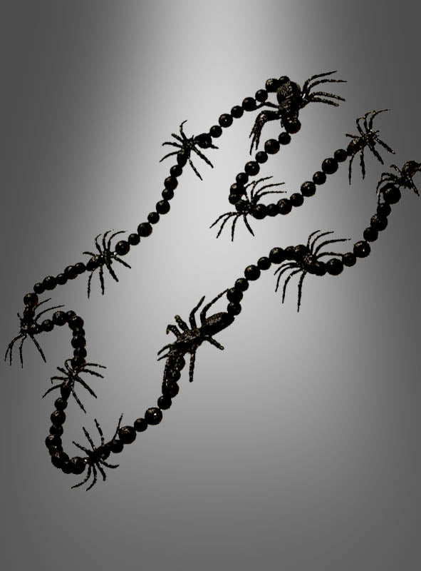 Eine schwarze Spinnengirlande (160 cm) mit schwarzen Perlen und mehreren schwarzen Plastikspinnen, ideal als Spinnendekoration oder Halloween-Dekoration, vor einem grauen Hintergrund mit Farbverlauf.
