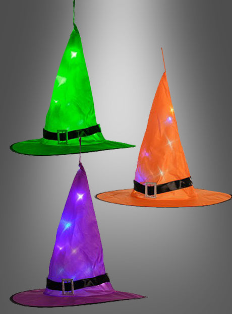 Drei leuchtende Hexenhüte (38 cm) in Grün, Orange und Lila sind mit schwarzen Bändern mit Schnallen versehen und mit kleinen, leuchtenden LED-Lämpchen verziert, die ihnen einen zauberhaften Touch verleihen – ideal als Halloween-Dekoration. Vor einem grauen Hintergrund mit Farbverlauf verleihen diese leuchtenden Hüte Ihrer festlichen Dekoration ein lebendiges Flair.