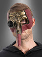 Ein Mann, der die „Steampunk Pestdoktor“-Maske trägt – eine Halbmaske mit bronzefarbenen Metallic- und roten Akzenten, die sich durch eine lange Nase und runde Augenöffnungen auszeichnet –, steht vor einem grauen Hintergrund.