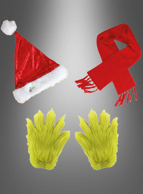 Das 3-teilige „Der Grinch“-Geschenkset, bestehend aus einer roten Weihnachtsmütze, einem roten Schal und einem Paar pelziger grüner Handschuhe, ist vor einem grauen Hintergrund mit Farbverlauf arrangiert.