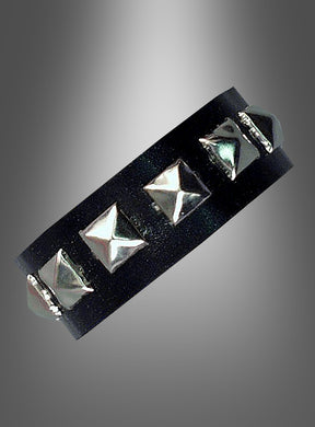 Ein schwarzes Lederarmband mit gleichmäßig verteilten silbernen Pyramidennieten, präsentiert vor einem grau verlaufenden Hintergrund – dieses Nietenarmband „Rocker Punk“ ist der perfekte 80er-Jahre-Schmuck und ein auffälliges Punk-Accessoire für jeden gewagten Look.