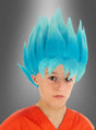 Ein Kind trägt die „Son-Goku-Kinderperücke blau aus Dragon Ball Super“ sowie ein orangefarbenes T-Shirt und posiert mit ausdruckslosem Gesicht vor einem grauen Hintergrund mit Farbverlauf; die blaue, stachelige Perücke erinnert an Son Gokus Verwandlung in den Super-Saiyajin Blue.
