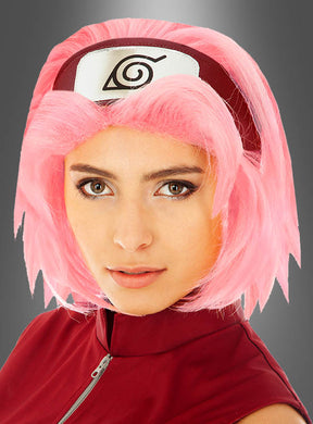 Eine Person, die eine rosa „Sakura“-Perücke für Erwachsene, ein rotes Outfit und ein Stirnband mit einem stilisierten Wirbel-Symbol trägt, posiert vor einem grauen Hintergrund mit Farbverlauf für ein beeindruckendes „Naruto Shippuden“-Cosplay.