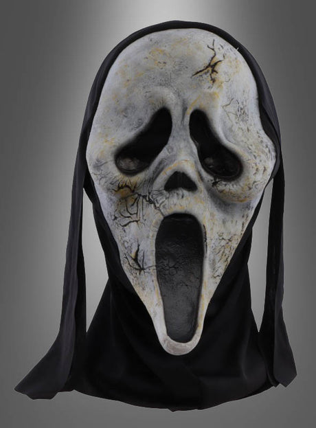 Die Original-„Scream“-Zombie-Maske mit einem weißen, rissigen Gesicht, einem langen, offenen Mund und hohlen Augen, die mit schwarzem Stoff drapiert ist, wird vor einem grauen Hintergrund mit Farbverlauf präsentiert.