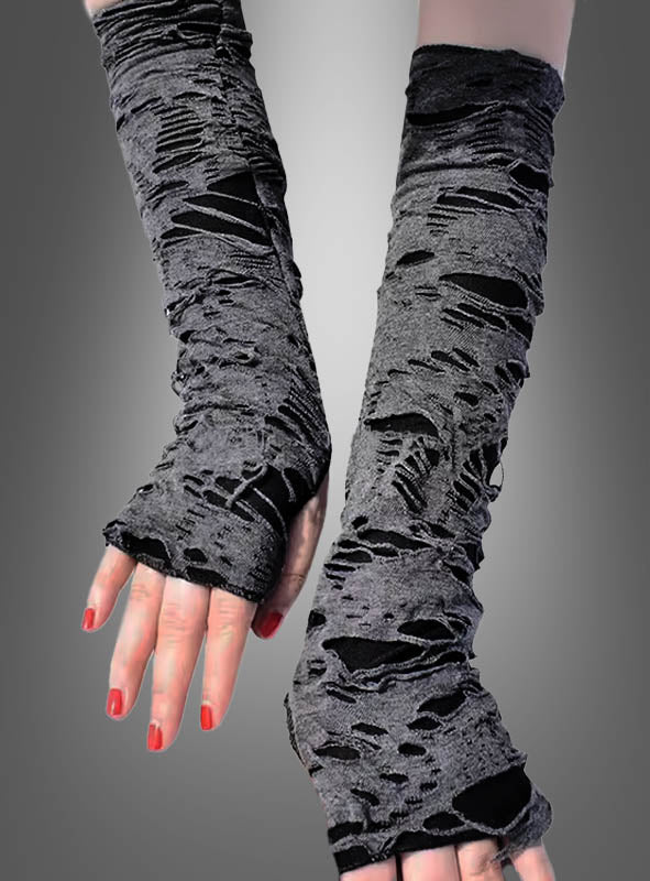 Zu sehen sind zwei Hände, die „Fetzige Zombie-Armstulpen“ tragen – lange, fingerlose Handschuhe im Used-Look in Grau, unter denen schwarzer Stoff durchscheint. Die Nägel sind in leuchtendem Rot lackiert und eignen sich perfekt für ein Halloween-Kostüm im Zombie-Stil. Der Hintergrund ist in einem neutralen Grau-Farbverlauf gehalten.