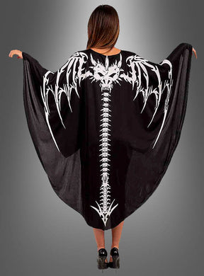 Ein Model trägt den „Drachen-Skelett-Umhang“ mit einem auffälligen Motiv aus einer weißen Fledermaus und einem Wirbelsäulen-Skelett auf dem Rücken; die Arme sind ausgestreckt, um das Design vor einem grauen Hintergrund zur Geltung zu bringen – ideal als Halloween-Kostüm oder Karnevalsumhang.