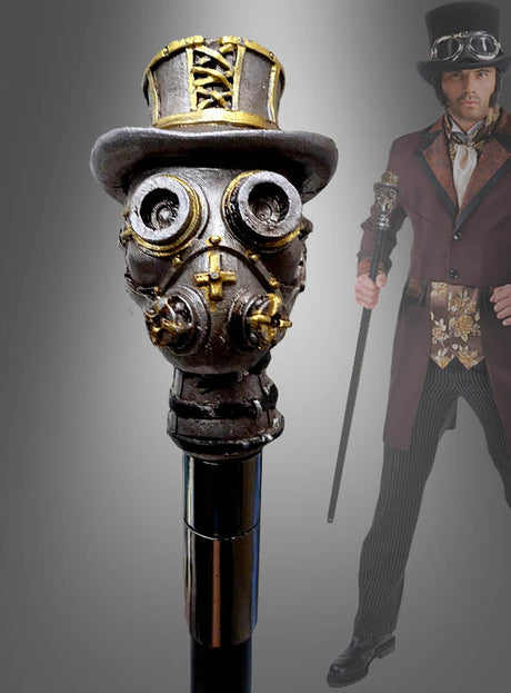 Im Hintergrund hält eine Person in einem Steampunk-Kostüm den „Deluxe Gehstock Steampunk“ – einen im Steampunk-Stil gestalteten Spazierstock mit einem Griff in Form einer Gasmaske, die einen Zylinder trägt – als auffälliges Kostümzubehör in der Hand.