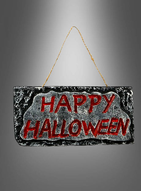 Das „Happy Halloween“-Schild (28 x 14 cm) ist ein rechteckiges Partyschild mit auffälligen roten Buchstaben, die „Happy Halloween“ auf einem schwarz-grauen, steinartigen Hintergrund bilden und an einer goldenen Schnur hängen – perfekt als festliche Halloween-Dekoration für Ihre Feier.