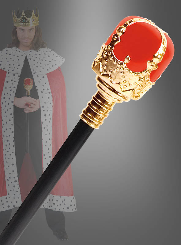 Eine Nahaufnahme des 47 cm großen „Zepter für Königskostüme“, einem unverzichtbaren Karnevalskostüm-Accessoire in Rot und Gold, mit einer unscharfen Gestalt im Hintergrund, die als König mit Krone und Umhang verkleidet ist.