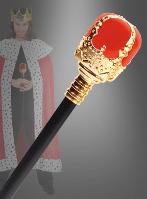 Eine Nahaufnahme des 47 cm großen „Zepter für Königskostüme“, einem unverzichtbaren Karnevalskostüm-Accessoire in Rot und Gold, mit einer unscharfen Gestalt im Hintergrund, die als König mit Krone und Umhang verkleidet ist.