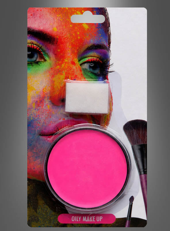 Auf der Verpackung ist eine Packung „Creme Make-up Pink mit Schwämmchen“ vor einem bunt bemalten Gesicht abgebildet. Das Produkt enthält rosa, cremiges Make-up mit einem Schwämmchen und einem Pinselapplikator und spiegelt damit perfekt den lebhaften Stil des K-Pop-Make-ups wider.
