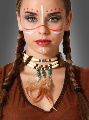 Mit einem Western-Indianer-Halsband aus Perlen mit Federakzenten, geflochtenen Haaren, Gesichtsbemalung und einem braunen Oberteil posiert diese Person vor einem grauen Hintergrund – perfekt, um jeder Wild-West-Mottoparty mit diesem auffälligen Stück Indianer-Schmuck authentisches Flair zu verleihen.