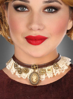 Eine Frau präsentiert den Steampunk-Halsschmuck – ein braun-weißer Spitzen-Choker, verziert mit goldenen Zahnrädern und einem Kameo-Anhänger –, kombiniert mit rotem Lippenstift und einem braunen Oberteil, vor einem grauen Hintergrund.