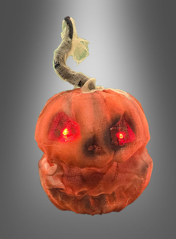 Der „Lachende Kürbiskopf“ (23 cm) mit Licht, der sich durch einen gewundenen Stiel, eine Netzhülle und leuchtend rote Augen auszeichnet, ist vor einem grauen Hintergrund mit Farbverlauf abgebildet.