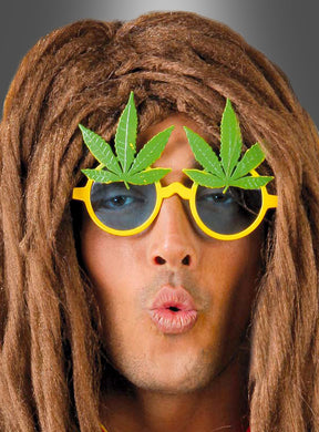 Mit der „Cannabis-Brille“ aus den 70er Jahren – einer gelben Sonnenbrille, die mit künstlichen Marihuana-Blättern verziert ist – und einer langen braunen Perücke formt diese Person mit dem Mund ein „O“ und rundet damit das Hippie-Kostüm-Accessoire für jede Retro-Party perfekt ab.