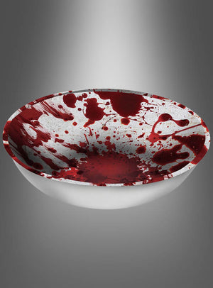 Eine XXL „Blutige Snackschale“ (31 cm), gefüllt mit roter Flüssigkeit, die so verspritzt und verteilt ist, dass sie wie Blut aussieht, steht vor einem schlichten grauen Hintergrund – perfekt als blutige Halloween-Schale für Ihre Vampir-Zombie-Party oder als auffällige Halloween-Tischdekoration.