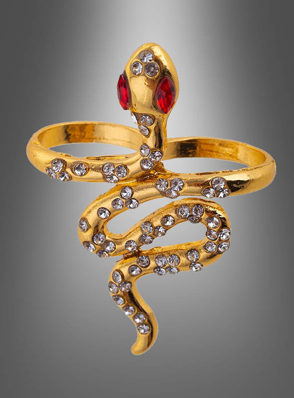 Der „Schlangen Ring“ Kostümschmuck ist ein goldfarbener Ring in Schlangenform, der mit roten Edelsteinaugen und klaren Strasssteinen entlang des Schlangenkörpers verziert ist und somit das perfekte Accessoire zur Vervollständigung Ihres Kleopatra-Kostüms darstellt. Abgebildet vor einem grauen Hintergrund mit Farbverlauf.
