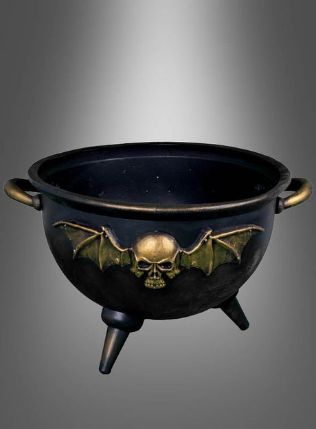 Ein riesiger schwarz-goldener Hexenkessel mit goldenen Henkeln und Füßen sowie einem goldenen Totenkopf mit Fledermausflügeln auf der Vorderseite, präsentiert vor einem grauen Farbverlauf – diese Hexenkessel-Halloween-Dekoration sorgt garantiert für einen eindrucksvollen Auftritt.