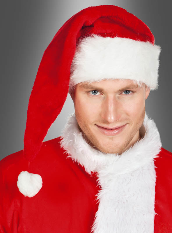 Eine Person, die ein rotes Weihnachtskostüm mit weißem Pelzbesatz und eine festliche Weihnachtsmann-Mütze aus Plüsch (Deluxe-Ausführung) trägt, steht vor einem grauen Hintergrund mit Farbverlauf und blickt in die Kamera.