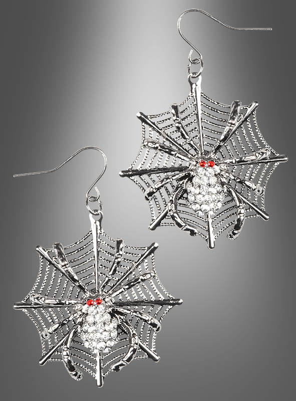 Verleihen Sie Ihrem Look einen Hauch von gruseliger Eleganz mit den „Spinnennetz“-Ohrringen – silberne Ohrringe in Spinnennetzform, verziert mit detailreich gearbeiteten Spinnen, die jeweils auffällige rote Edelsteinaugen und funkelnde klare Kristalle aufweisen. Diese Ohrringe eignen sich perfekt als Halloween-Accessoire und werden hier vor einem grauen Hintergrund mit Farbverlauf präsentiert.