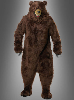 Eine Person, die das „Grizzly Bär Kostüm braun Deluxe“ mit Motion-Maske trägt – mit scharfen Krallen und einem Ausdruck mit offenem Maul –, steht vor einem grauen Hintergrund.