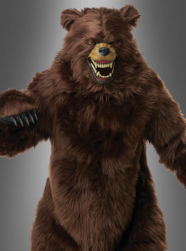 Eine Person, die das „Grizzly Bär Kostüm braun Deluxe mit Motion-Maske“ trägt – mit realistischen Details wie Knurren, sichtbaren Zähnen und Krallen –, posiert vor einem schlichten grauen Hintergrund. Dieses Deluxe-Bärenkostüm bietet lebensechte Bewegungseffekte für einen unvergesslichen Auftritt.