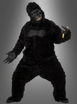 Eine Person, die das Gorilla-Kostüm mit beweglicher Ani-Motion-Maske trägt – ein komplett schwarzer Ganzkörperanzug mit einer Maske mit gelben Zähnen –, steht vor einem grauen Hintergrund mit Farbverlauf, wodurch sich das Kostüm ideal als Tierkostüm für den Karneval eignet oder für alle, die ein Gorilla-Kostüm in Größe XL suchen.