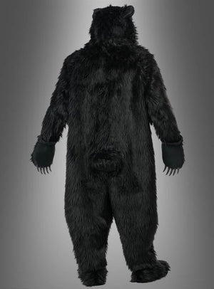 Eine Person, von hinten gesehen, die Arme leicht ausgestreckt, im „Schwarzbär-Kostüm Deluxe mit Ani-Motion-Maske“ vor einem grauen Hintergrund mit Farbverlauf.
