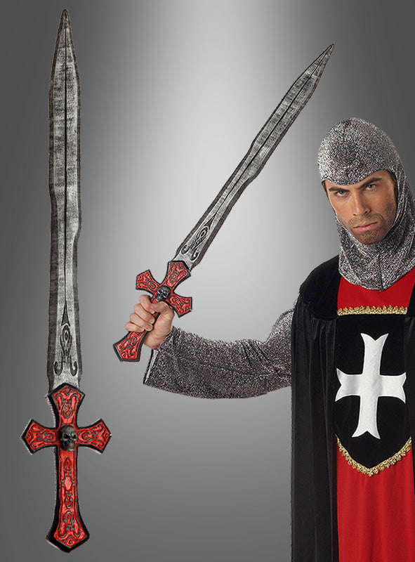 Ein Mann in mittelalterlicher Ritterkleidung hält ein 90 cm langes Kreuzritter-Schwert mit einem roten, kreuzförmigen Griff und einer langen, silbernen Klinge in der Hand; das Schwert wird zudem in Nahaufnahme gezeigt.