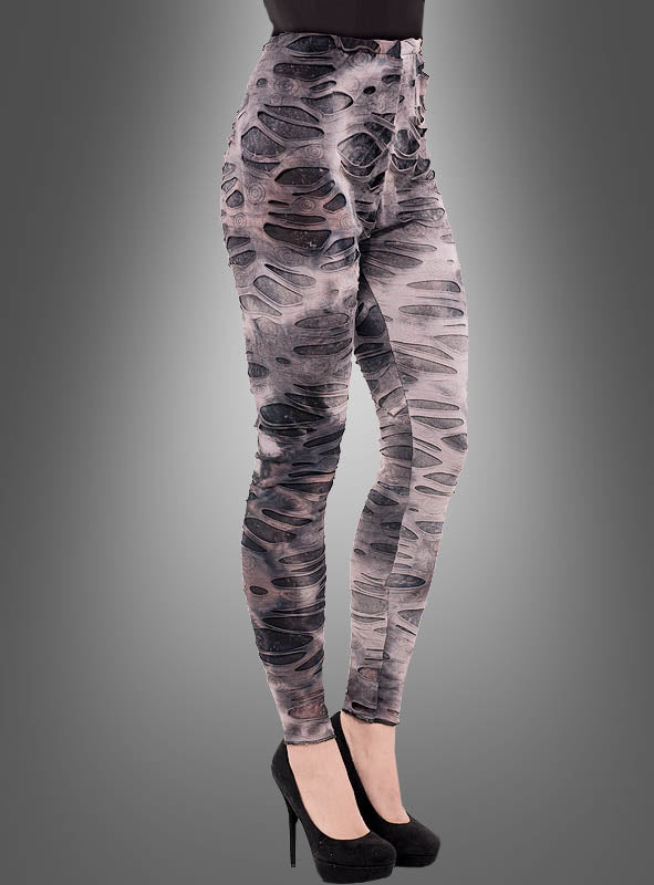 Eine Person trägt „Fetzige Zombie-Leggings“ – graue Leggings mit hoher Taille, im Used-Look und mit schwarzen Mustern –, kombiniert mit schwarzen Stöckelschuhen, und posiert vor einem schlichten grauen Hintergrund. So entsteht eine auffällige Option für ein Halloween-Kostüm oder ein ausgefallener Lagenlook für deinen Stil.