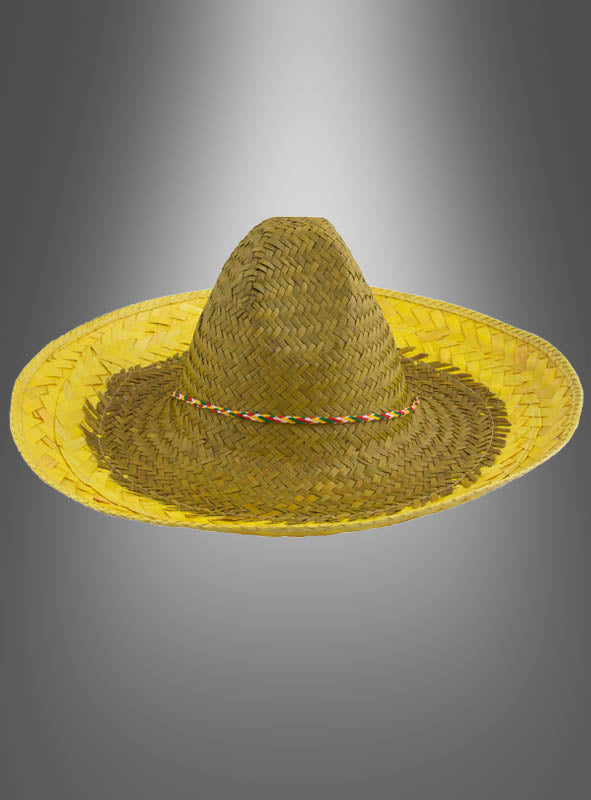Der „Mexikaner Hut Sombrero Unisex“ besticht durch sein breitkrempiges Design aus geflochtenem Stroh und ein farbenfrohes, mehrfarbiges Flechtband – ein ideales Accessoire, das jedes Amigo-Kostüm perfekt ergänzt – hier vor einem grau verlaufenden Hintergrund abgebildet.