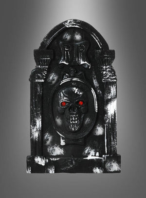 Das „Grabstein Halloween – Verschiedene Designs“-Set besteht aus einem schwarzen Grabstein-Requisit mit einem Totenkopf und leuchtend roten Augen, auf dessen Oberseite „RIP“ eingraviert ist, vor einem grauen Hintergrund mit Farbverlauf – perfekt als Halloween-Dekoration und als auffälliger Grabstein für Ihre gruselige Dekoration.