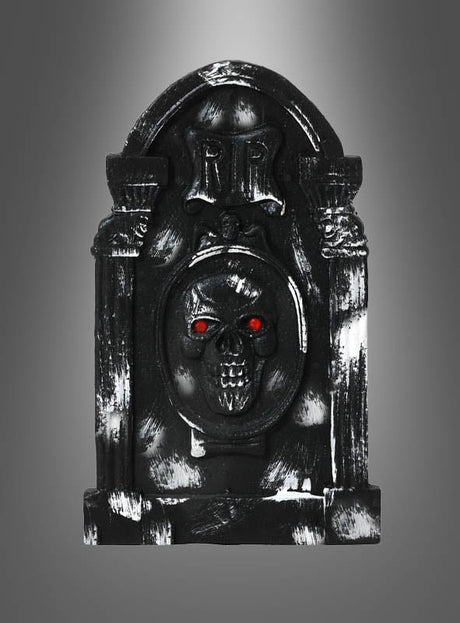 Grabstein Halloween – verschiedene Designs: ein schwarzer Grabstein mit einem Totenkopf und leuchtend roten Augen, versehen mit der Aufschrift „RIP“, fotografiert vor einem grauen Hintergrund mit Farbverlauf. Diese Halloween-Dekoration eignet sich perfekt für Ihre gruseligen Feierlichkeiten und verleiht jeder Spuk-Kulisse eine unheimliche Note.