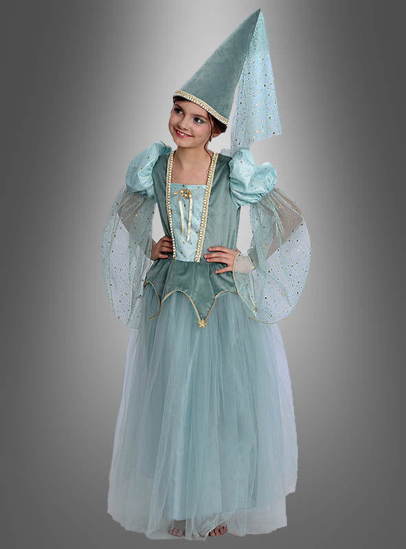Ein Kind, das das „Traumhaftes Prinzessin Kleid Adelia Kinderkostüm“ trägt – ein hellblaues Märchenkostüm im mittelalterlichen Stil mit Puffärmeln, einem langen Tüllrock und einem hohen, spitzen Hut, der mit einem wallenden Schleier verziert ist –, steht vor einem grauen Hintergrund.
