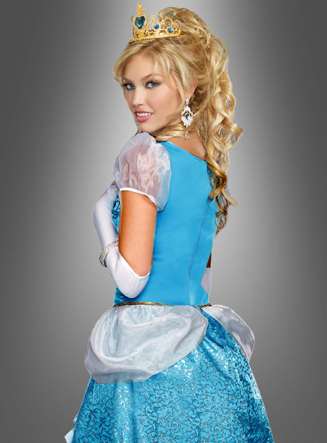 Eine Frau im „Märchenhaften Ballkleid Prinzessin“, dazu Handschuhe, Ohrringe und eine Tiara, steht vor einem grauen Hintergrund und blickt über ihre Schulter.